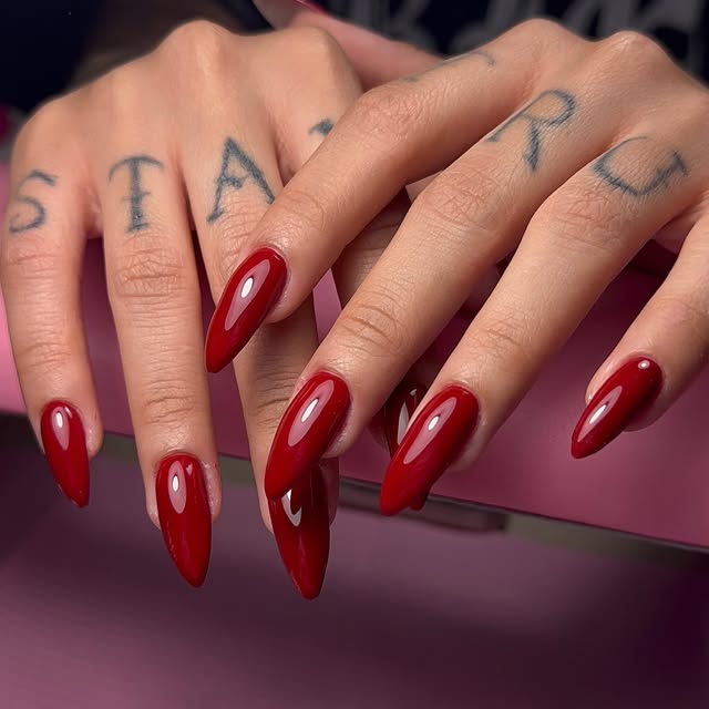 Deep red stiletto nails by Ofir